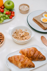 Light healthy Breakfast with oatmeal. Hercules, nuts, fruit, boiled eggs, bread. Tableware. Healthy food.