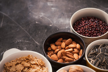 Different kinds of nuts in bowls.