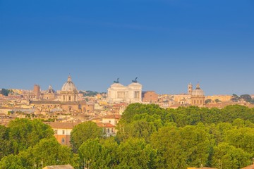 Obraz na płótnie Canvas Beautiful view of Rome, Italy. Sunny summer evening. Aerial panoramic cityscape of Rome. Rome skyline with the dome of Saint Agnese Church, the Campidoglio and the Altare della Patria monument.