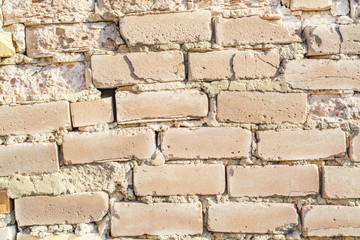 The background of the old wall of white brick, cracked