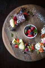 Meringue with berries and chocolate brownie pudding plate