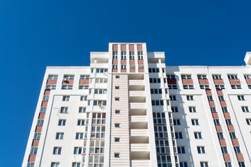 White multi-storey building against a blue sky