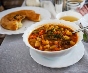Lagman in a white plate against a white tablecloth, Tatar cuisine
