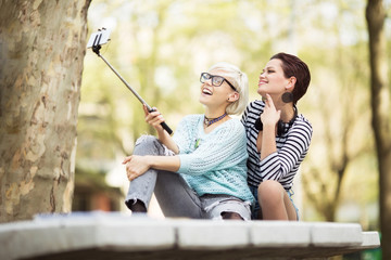 Young and cute female students taking selfies in front of a camera