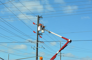 Lift bucket with service men working on hydro lines