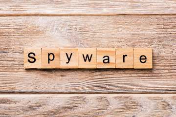 spyware word written on wood block. spyware text on wooden table for your desing, concept