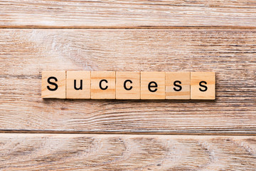 success word written on wood block. success text on wooden table for your desing, concept