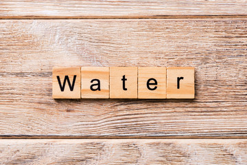 water word written on wood block. water text on wooden table for your desing, concept