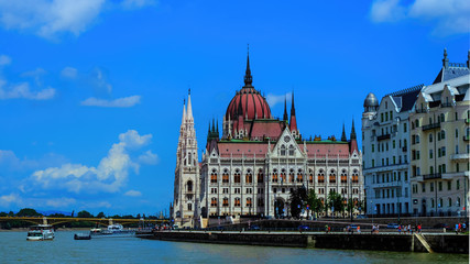 Fototapeta premium Hungarian parliament building view from river Danube with light clouds at sky, selective focus