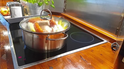 Vegetables and chicken cooking in a metal pot