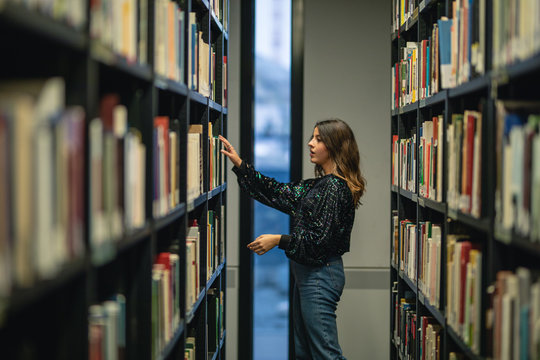 young student in the library have fun in a diktionary bookshelf colorated in Berlin by #tigerraw