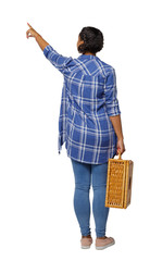 Back view of a young black girl in jeans with a picnic bag.