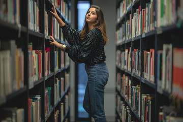 woman with books in library