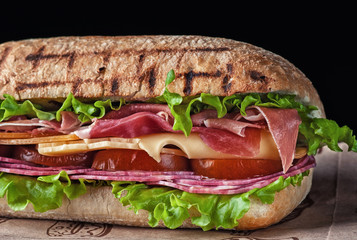 sandwich with proshutto tomatoes and cheese salami