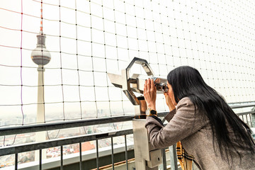 Girl looks at Berlin TV tower from binoculars © pavelgulea