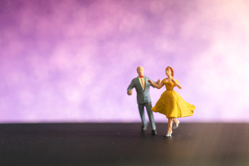 Miniature people , Couple dancing with colorful  background