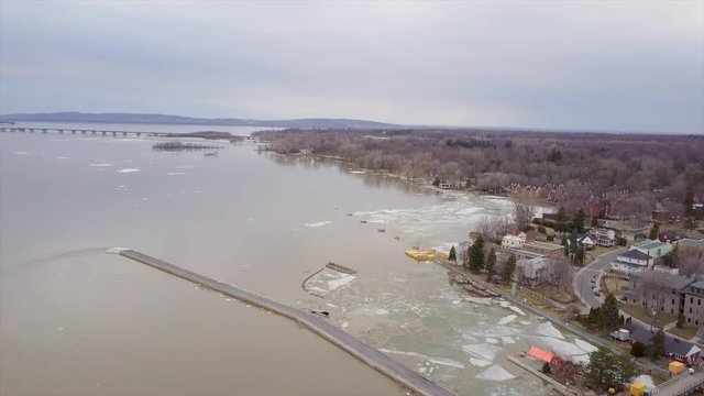 Cinematic drone / aerial footage moving forwards showing ice blocks on Saint Lawrence River near Montreal, Quebec, Canada during pre-spring season.