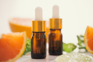 organic cosmetics with herbal extracts of lemon, orange, mint on bright background
