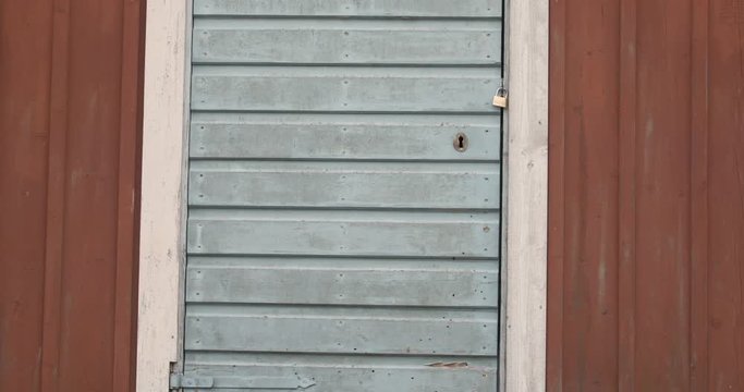 Old Abandoned Farm House barn with a time worn wooden door and a new padlock. - Powered by Adobe
