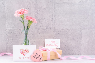 Mothers day handmade giftbox surprise wishes photography - Beautiful blooming carnations with pink ribbon box isolated on gray wallpaper design, close up, copy space