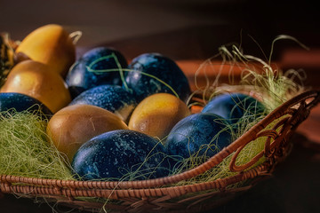 Painted Easter eggs in a straw basket