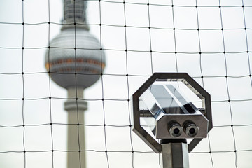 Obraz premium Television tower in Berlin and telescope near
