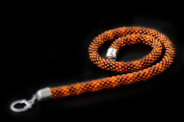 Amber color necklace on a dark background close up