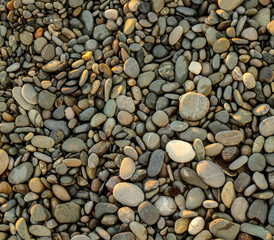 Stone pebbles on the seashore as an abstract background