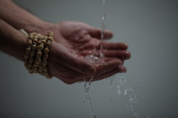 Muslim man washes his hands before prayer ritual cleansing.