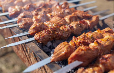 Shish kebab on skewers is fried on a brazier