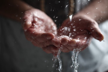 Fototapeta premium Muslim man washes his hands before prayer ritual cleansing.