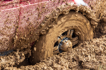 Car wheel slips in the dirt in nature