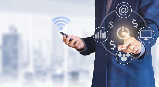 Asian businessman use smartphone and pointing at power to start working with various icons. Concept business, investment