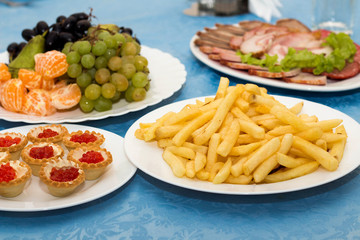 The range of different dishes on the table with a blue tablecloth, restaurant, benket