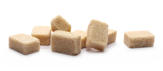 Brown cane sugar cubes isolated on white background