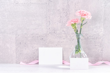 Mothers day handmade giftbox surprise wishes photography - Beautiful blooming carnations with pink ribbon box isolated on gray wallpaper design, close up, copy space, mock up