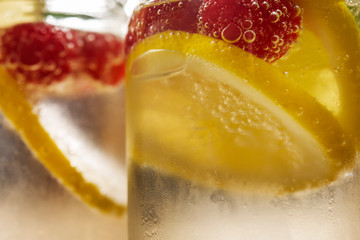 close-up cold lemonade with berries in glass jar