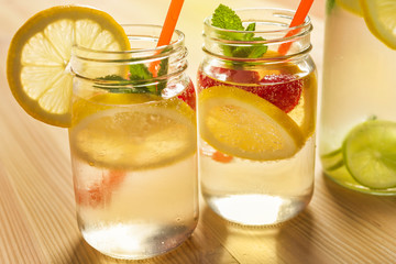 summer cold sodas with lemon and berries in jar