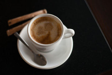 Cup of coffee on the black table.