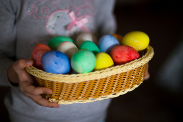 Fototapeta na wymiar Cute little girl with bunny ears holding bright Easter egg