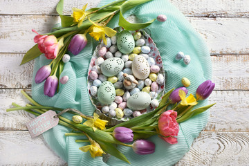 easter card design with spring flowers around the bowl with eggs