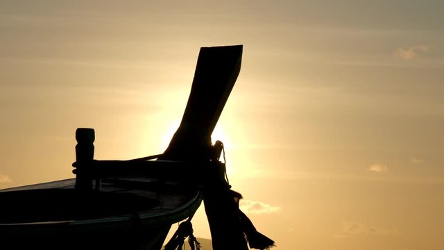 Traditionnal Long tail boat at sunset in Thailand