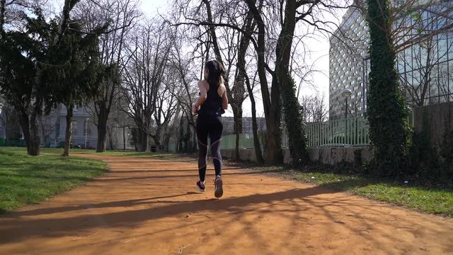 Image of fitness woman running at park during sunny day, Zagreb, Croatia.