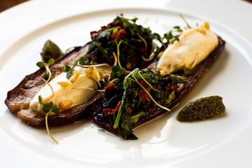 Baked eggplant with soft cheese and pesto sauce