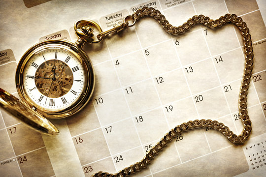 Time management, pocket watch on calendar