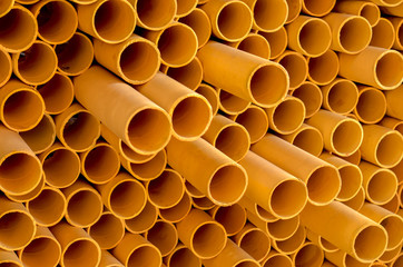 Side view of Abstract art structure created by stacking yellow pvc pipes together at an exhibition