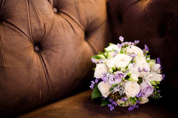 Bouquet in brown sofa - Purple and creamy roses.