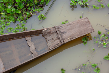 Top view the prow of wooden boat as it floats on canal