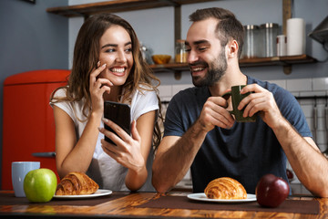 Beautiful cheerful couple having breakfast