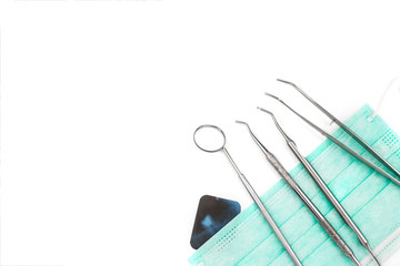 Dentist tools on mask and x-ray photo.